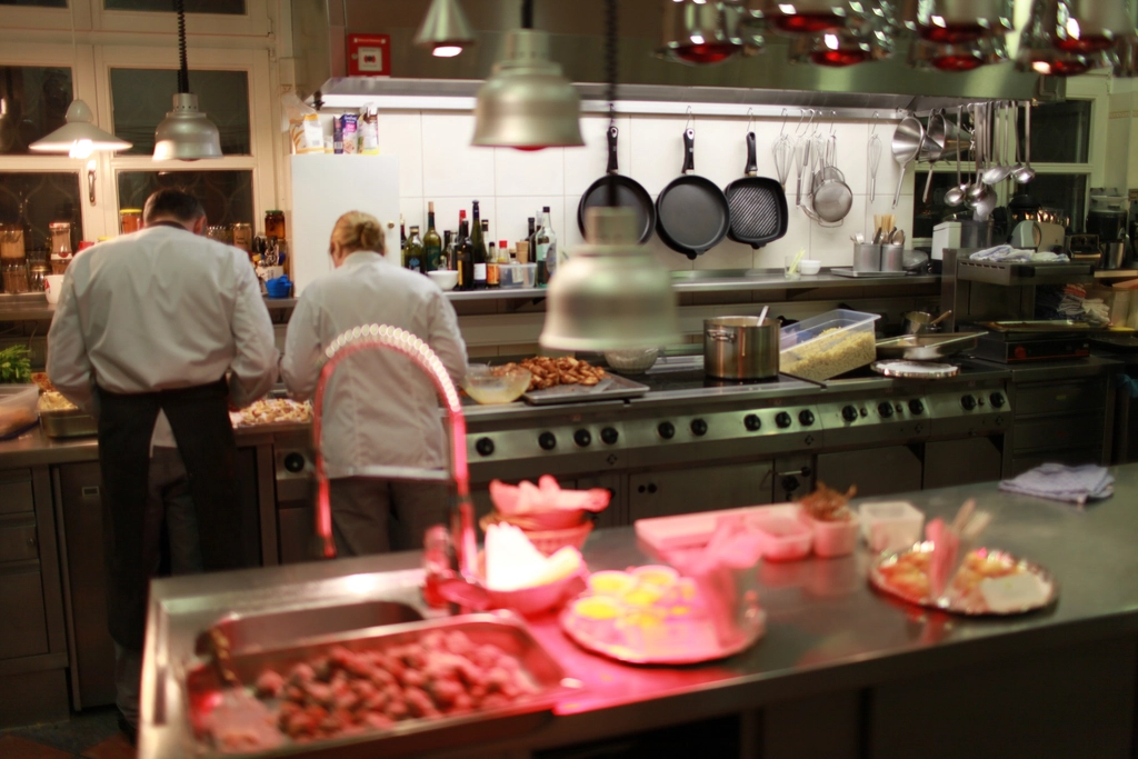 Kitchen team preparing food in a busy hospitality venue