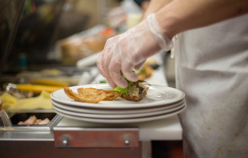 Chef plating dishes in a busy restaurant kitchen