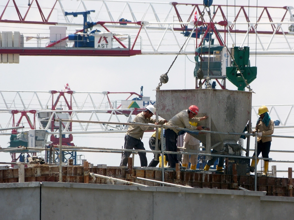 Construction crew working at height on a busy building site