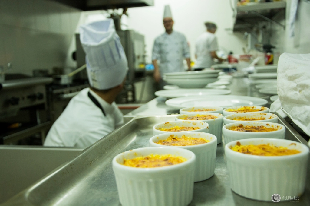Chefs plating meals during service in a restaurant kitchen