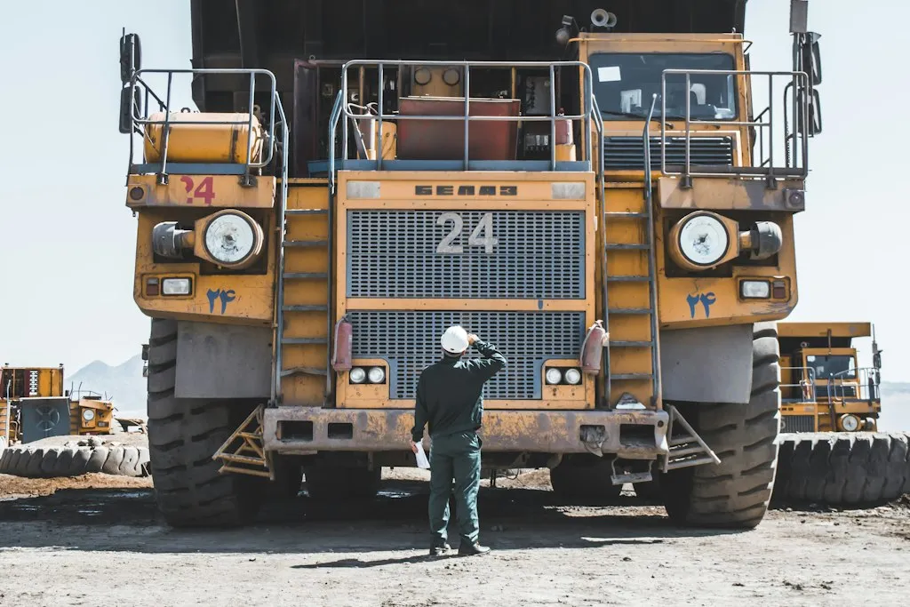 Mine worker standing in front of a haul truck
